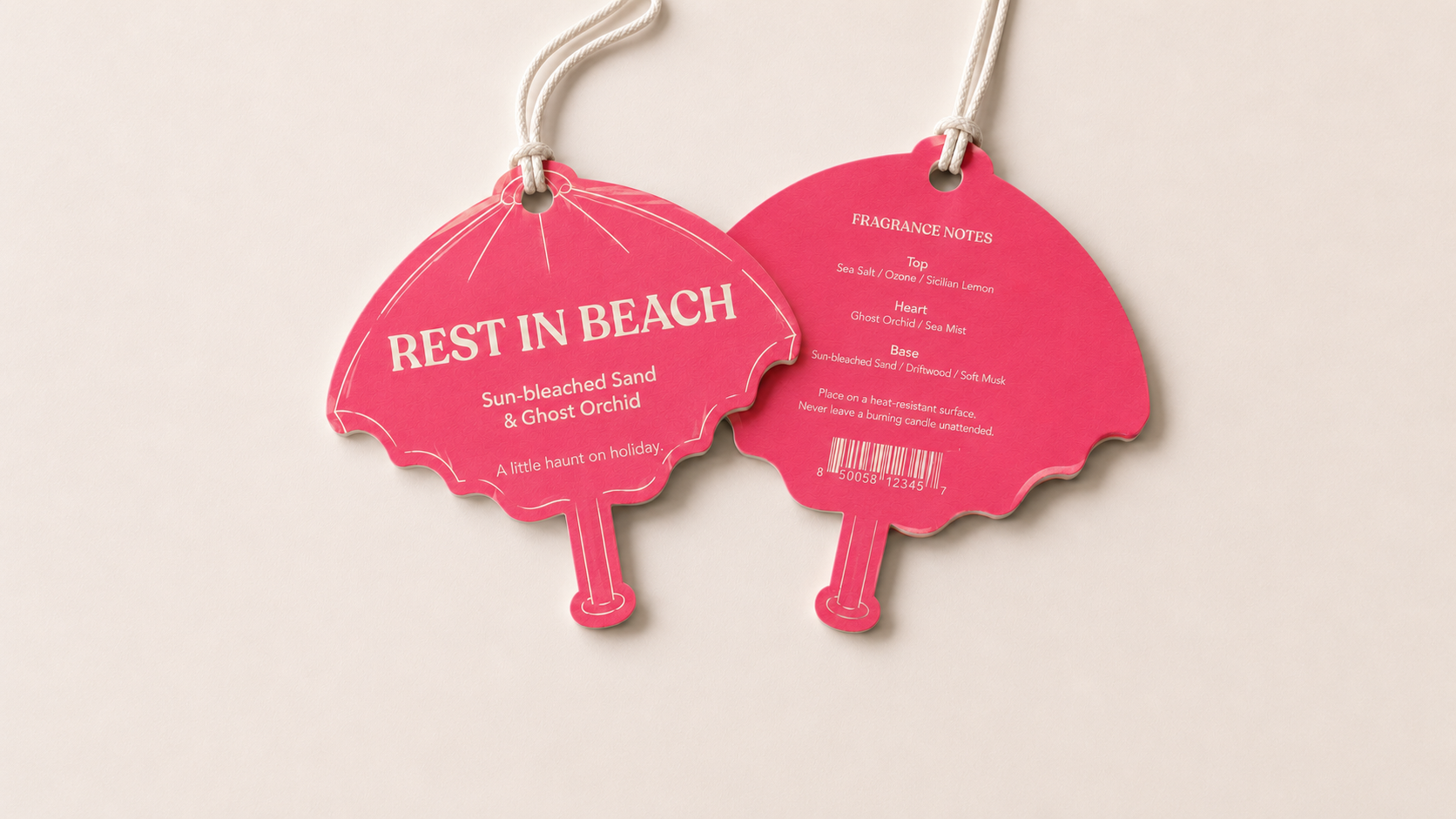 Front and back of a pink parasol-shaped Rest in Beach swing tag.